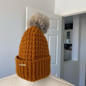 Michael Kors pull on hat with fur ball. Cute
